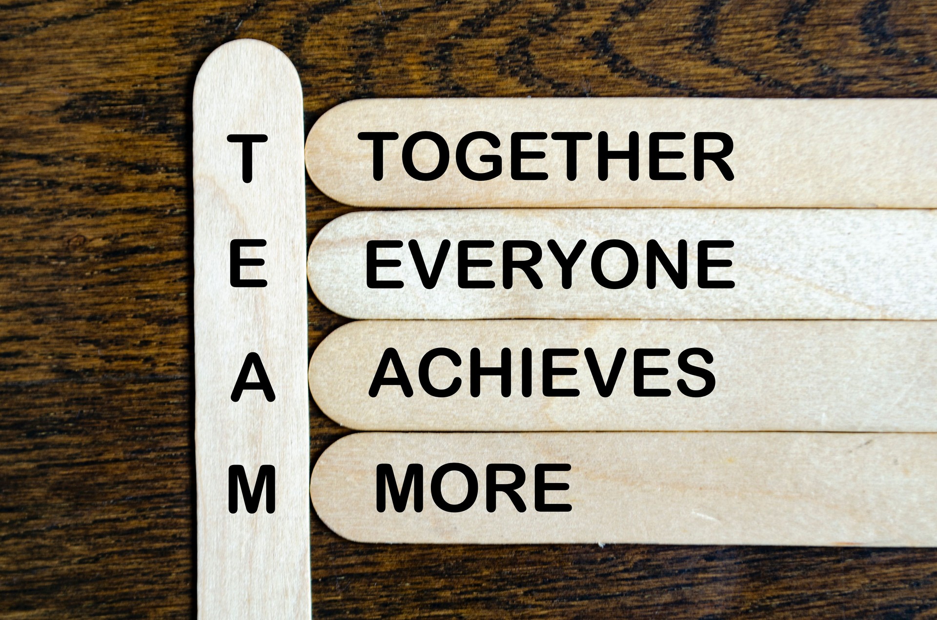 TEAM representing Together Everyone Achieves More text on wooden stick. TEAM representing Together Everyone Achieves More text on wooden stick.